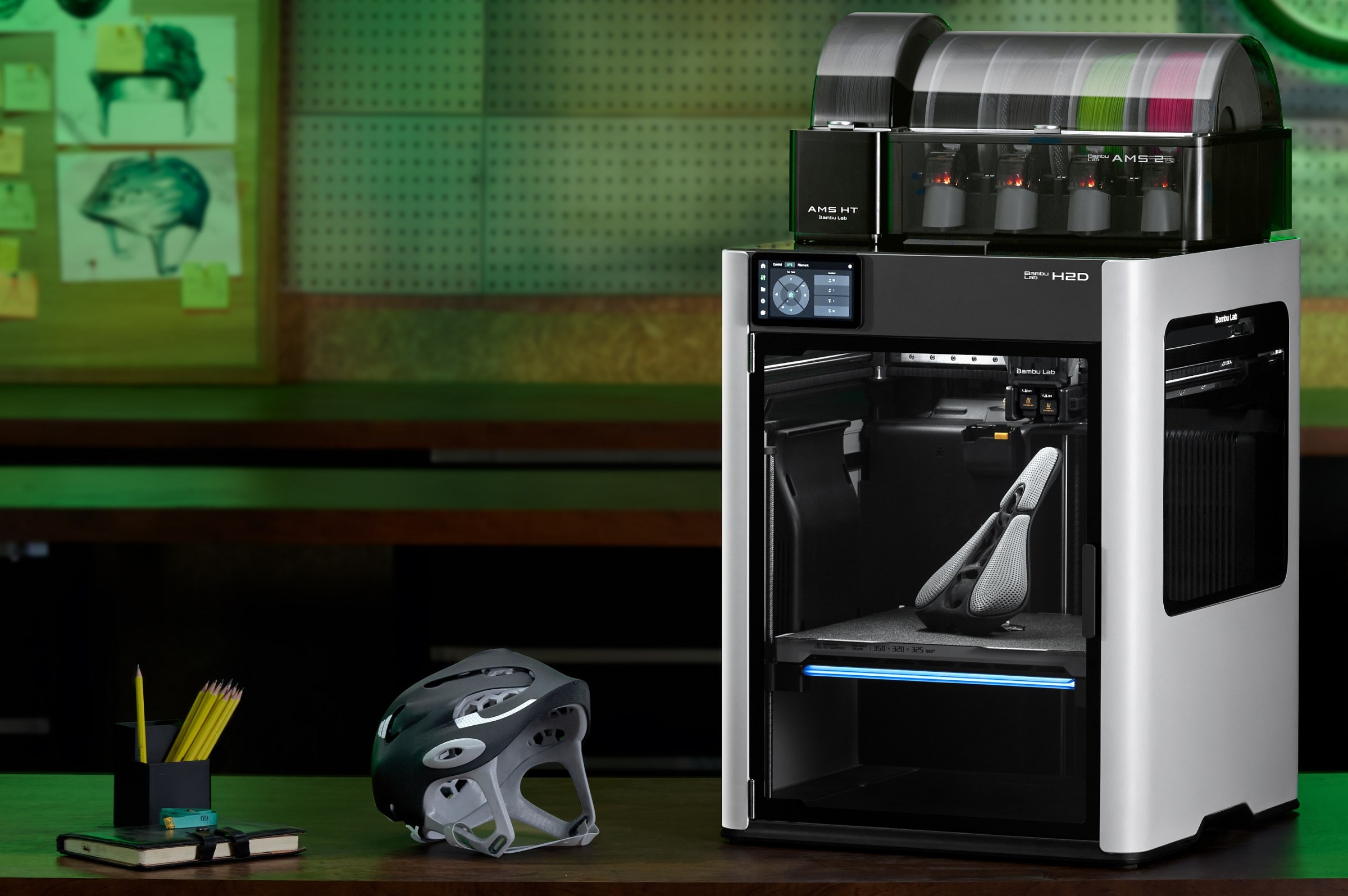 The Bambu H2D with both new AMS units and examples of prints that use both hard and soft plastics.