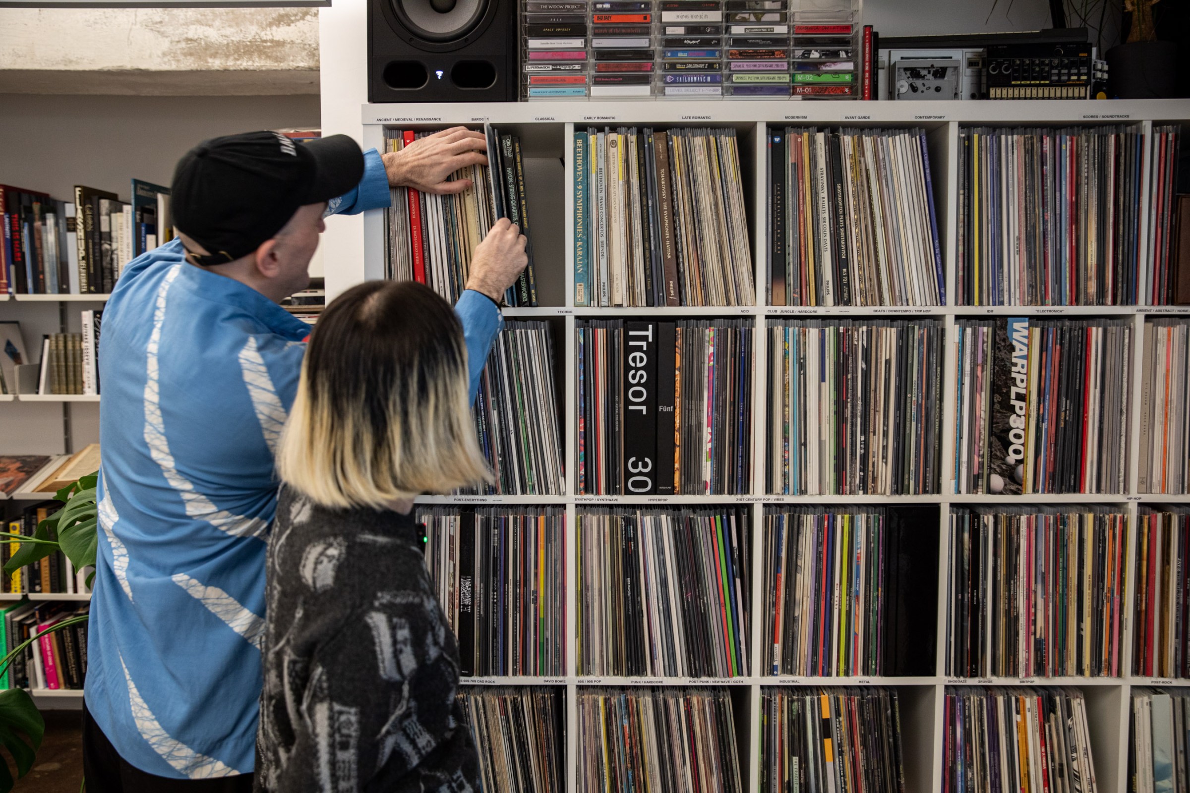 Max selects a record from the couple’s well-organized vinyl collection using a pair of multisided dice. The couple developed a game where house rules dictate whatever record is pulled must be played from start to finish.