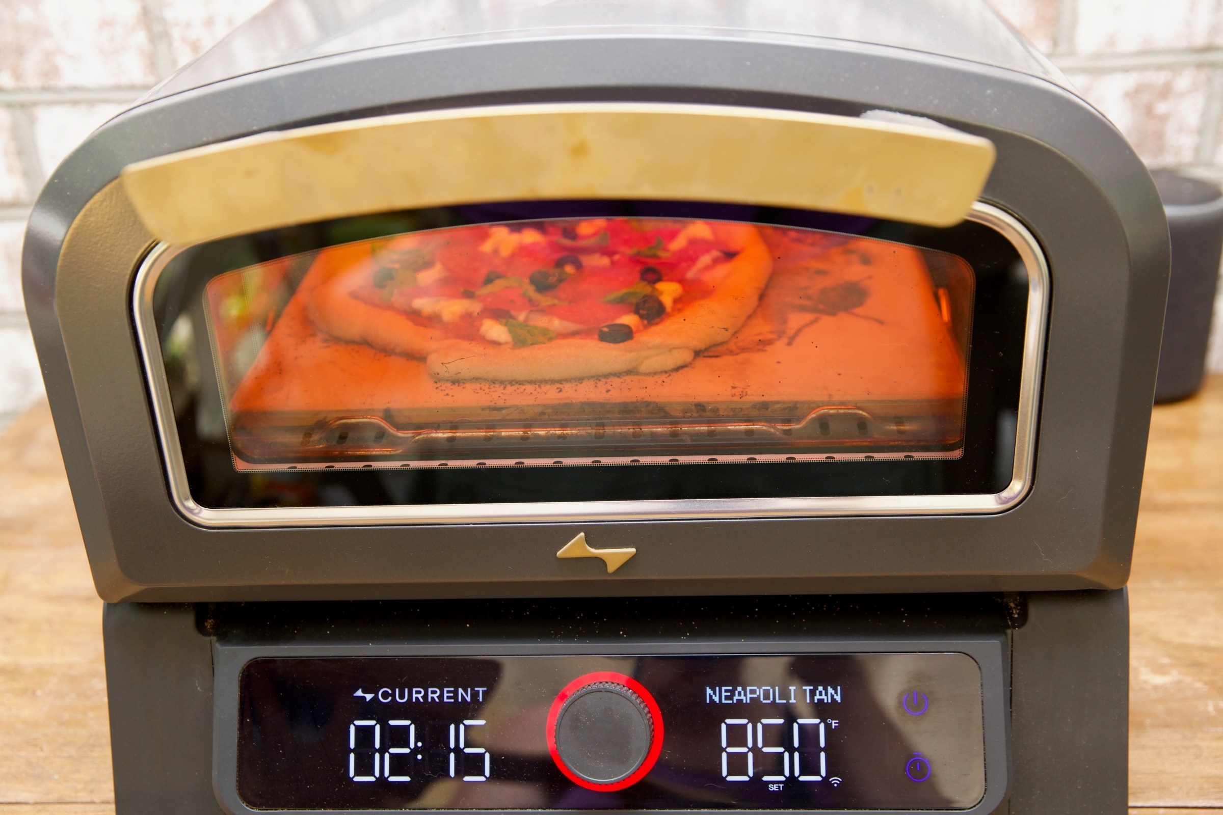 The Current pizza oven is compact and easy to use. It can be used indoors or outdoors. However, its exterior gets very hot, so you need to position it away from walls or anything flammable.