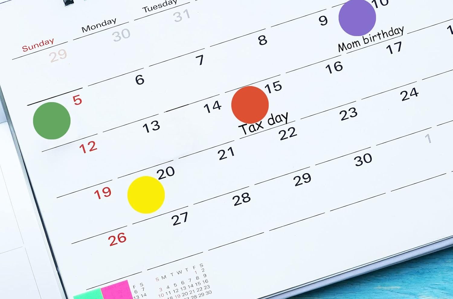 Calendar with colored dots on several days.