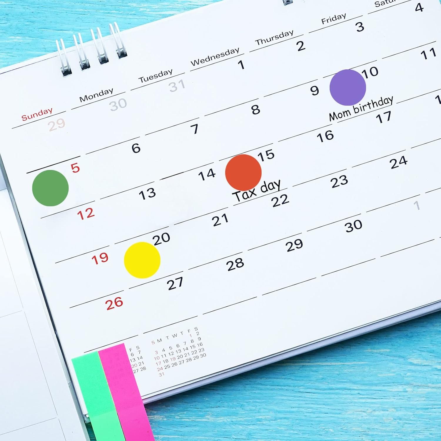 Calendar with colored dots on several days.