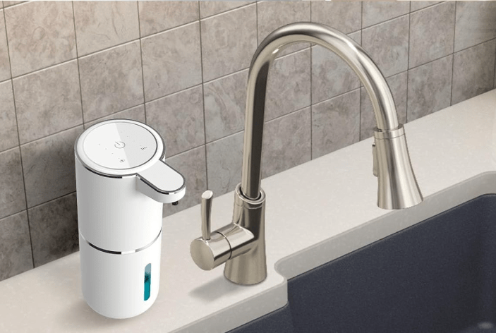 Soap dispenser next to faucet.