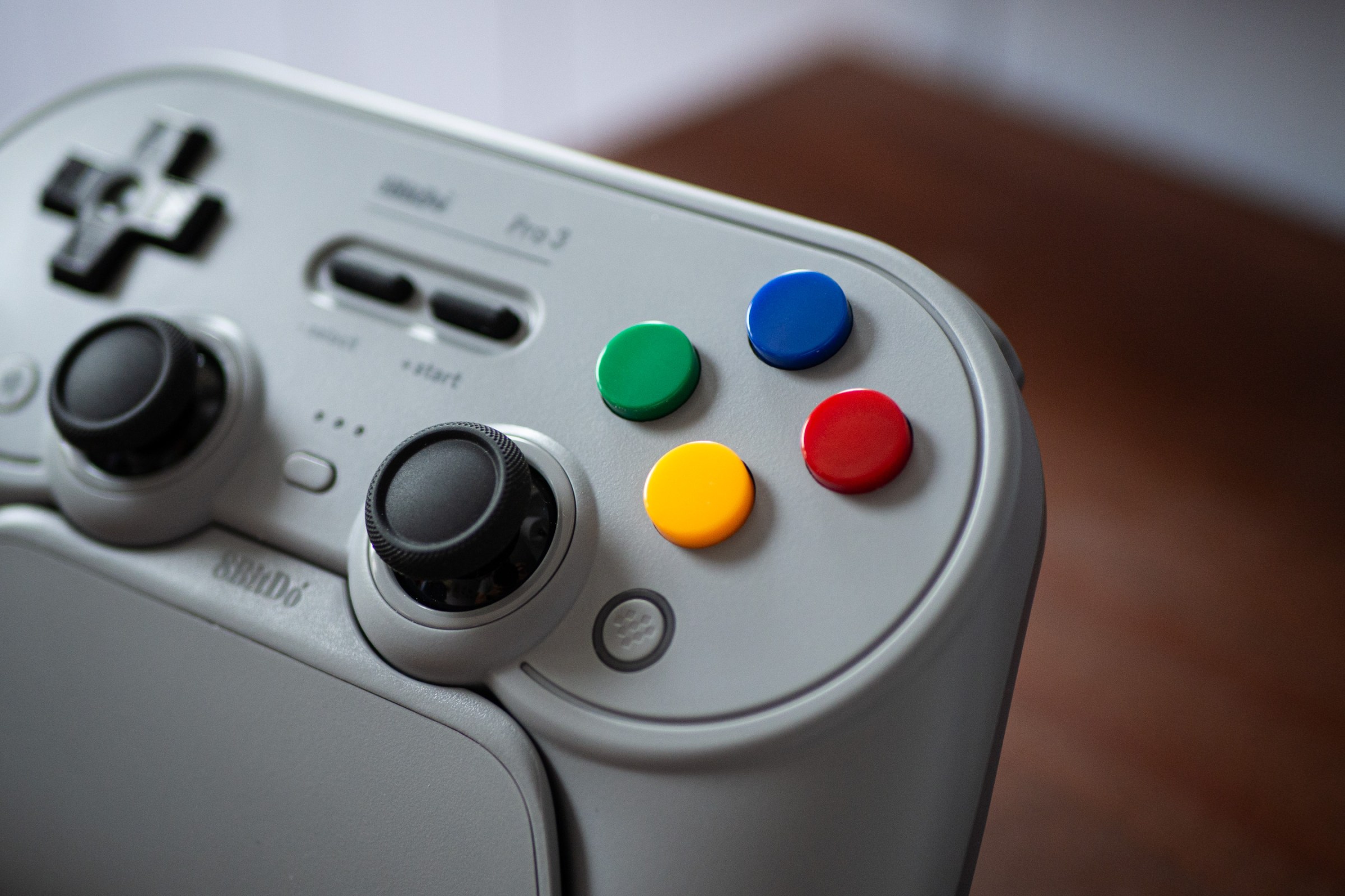 A close-up image of the colorful face buttons that can be put on the 8BitDo Pro 3 gaming controller. They mirror the style of the Super Famicom face buttons.