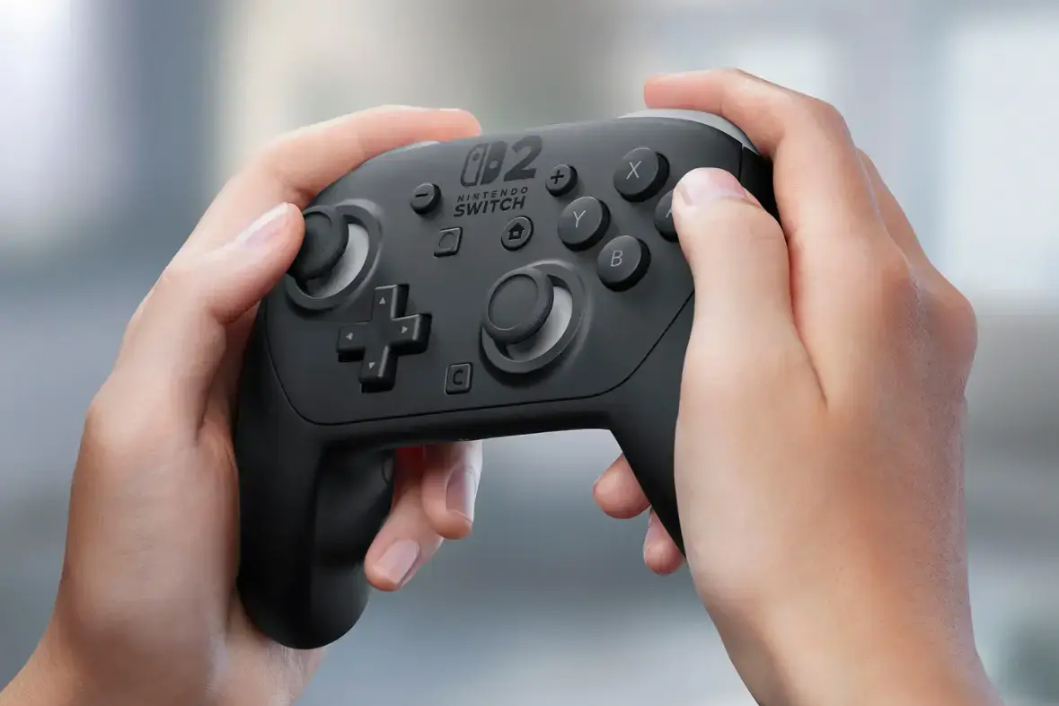 A close-up image of a pair of hands holding the Nintendo Switch 2 Pro Controller at a slight angle.