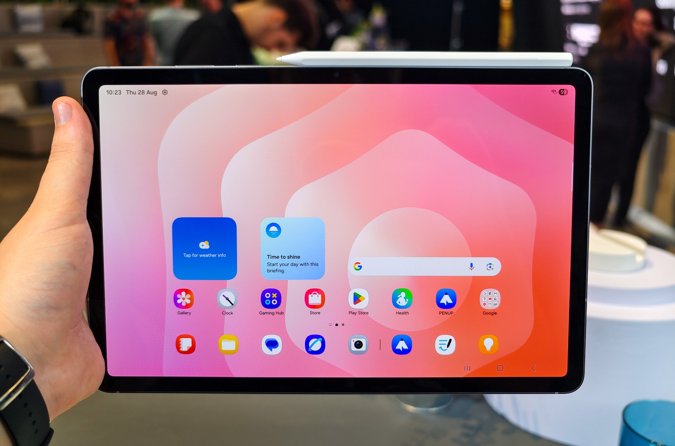 Samsung Galaxy Tab S11 with S Pen attached showing the home screen