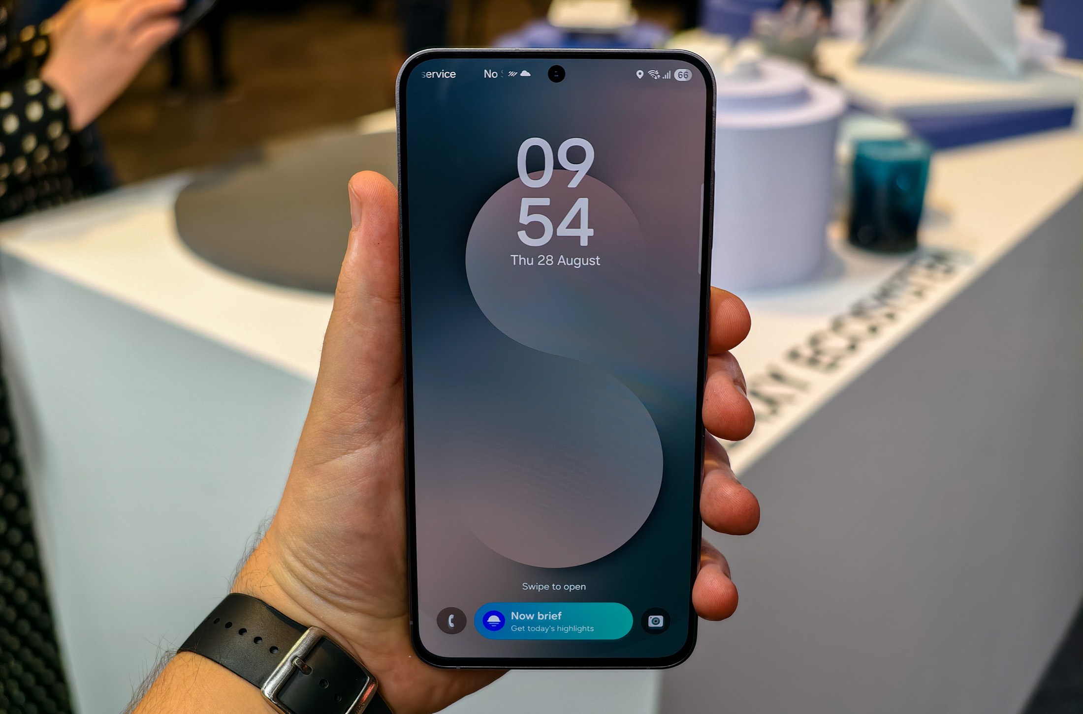 Samsung Galaxy S25 FE in a hand with the lock screen showing
