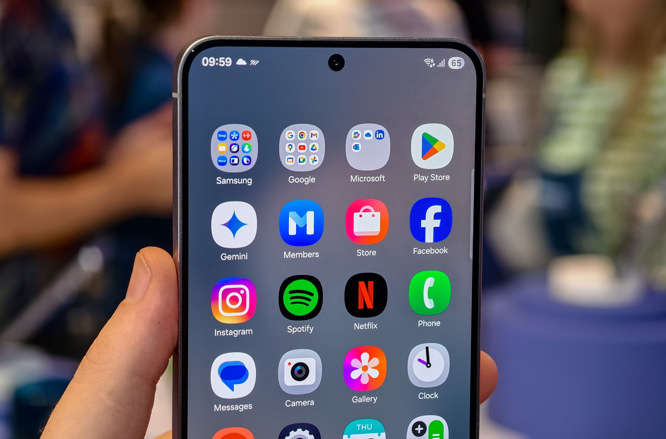 Samsung Galaxy S25 FE in a hand with the app drawer showing