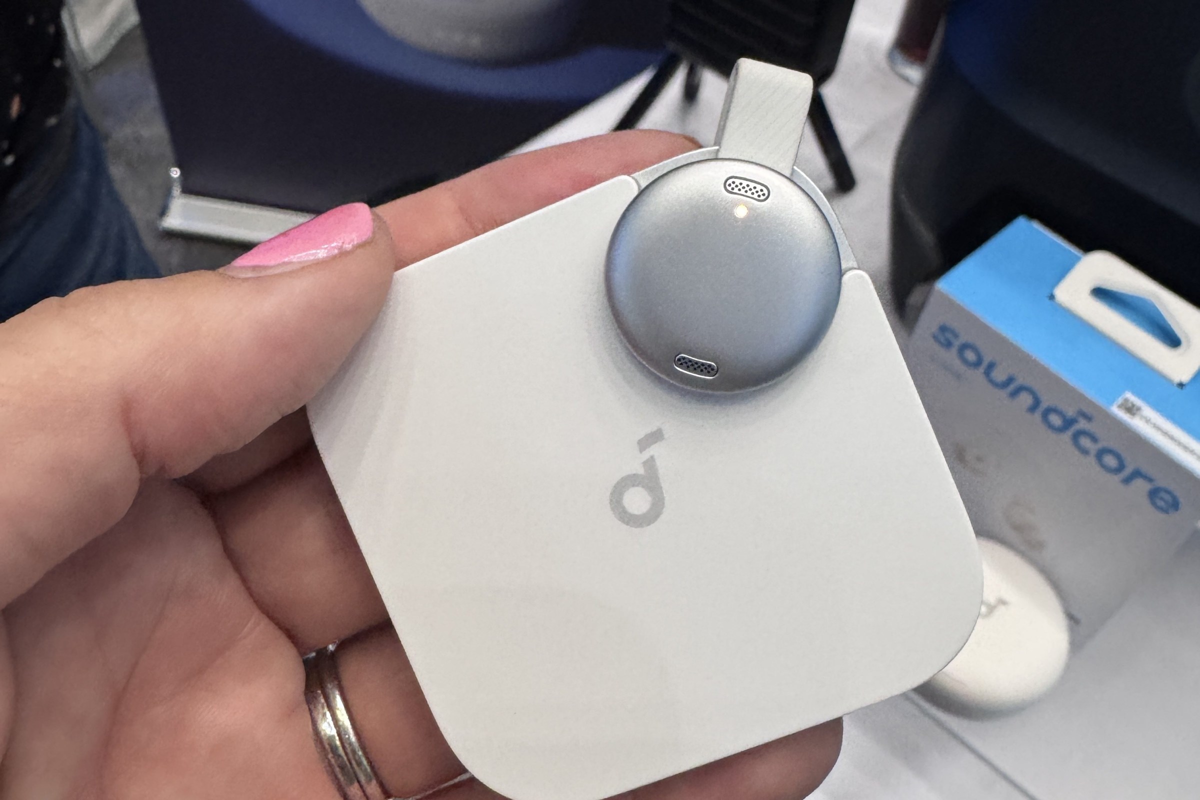 The Anker Soundcore Work AI voice recorder being held in a womans hand.