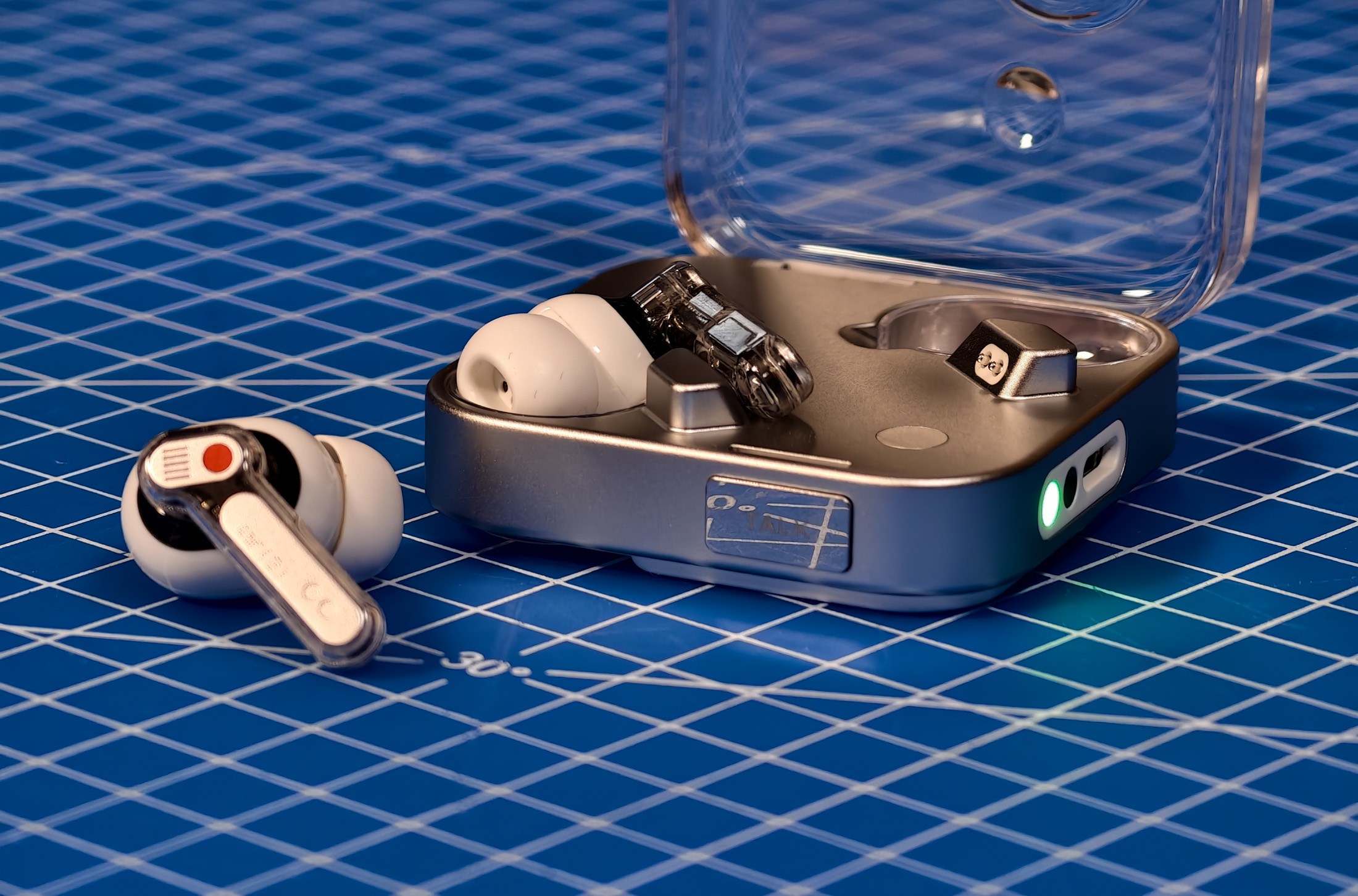 Nothing Ear 3 in the case on a blue mat