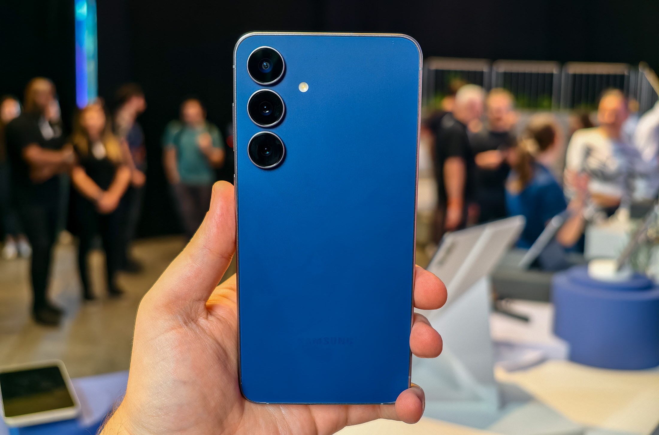 Samsung Galaxy S25 FE in navy blue held in a hand