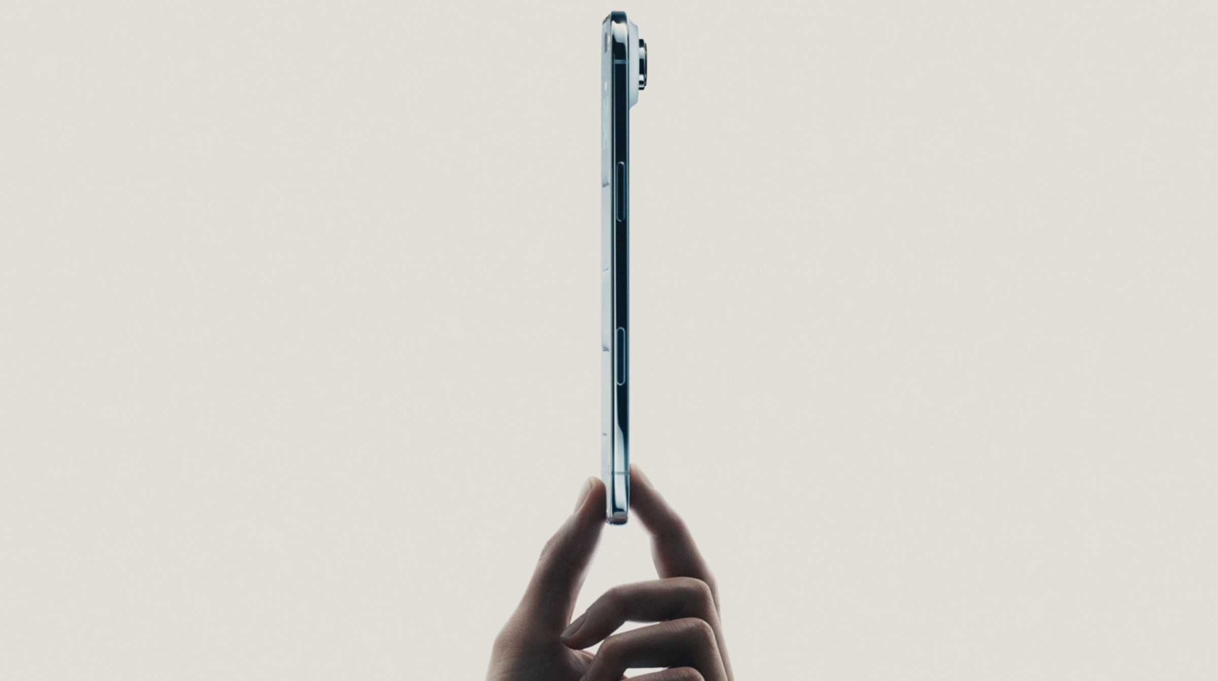 An image showing the side-profile of the iPhone Air held between two fingers.