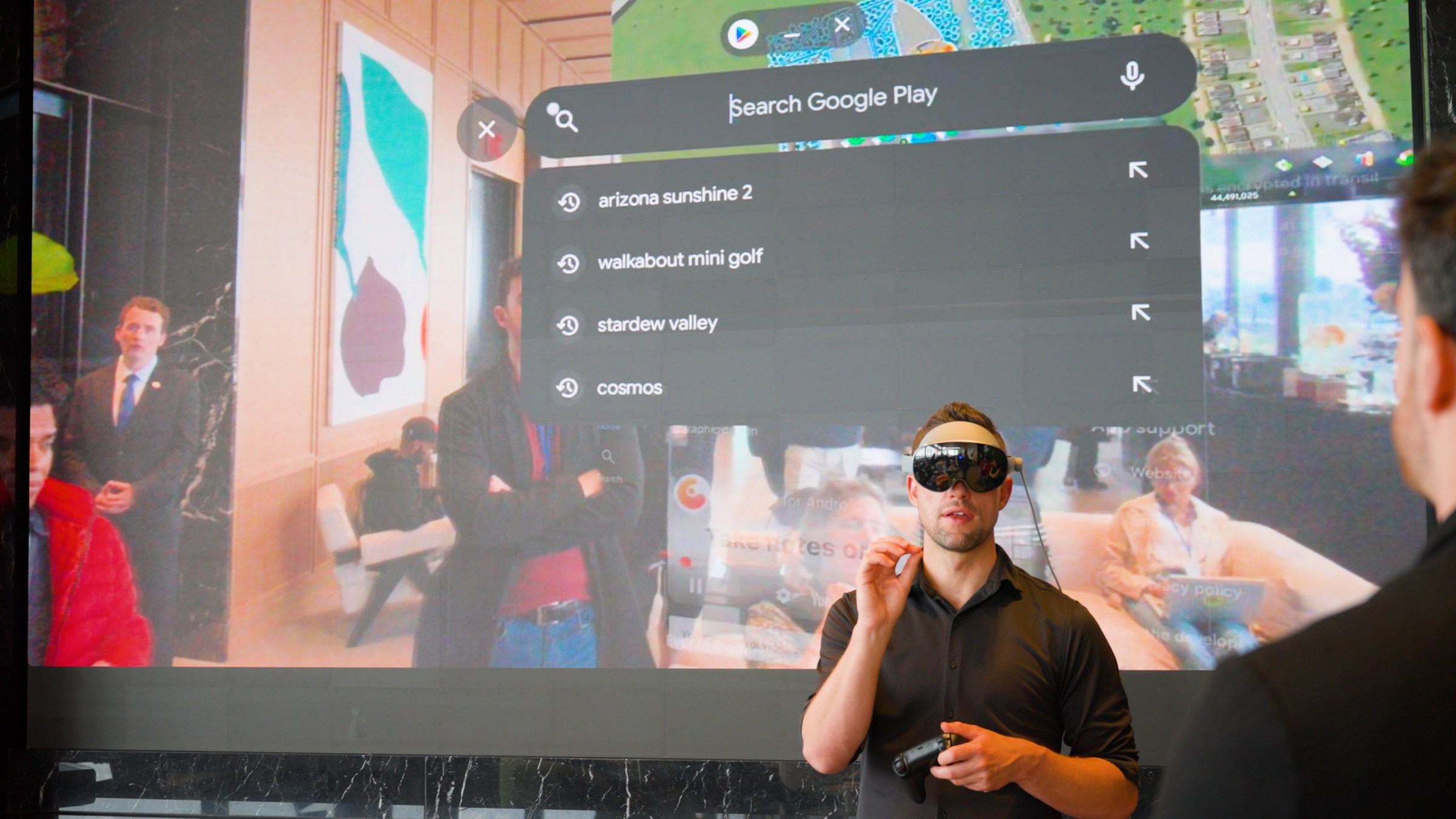Man uses Galaxy XR headset in from of a screen.